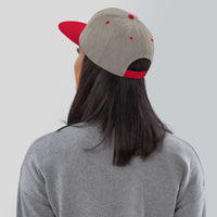 Female model in heather grey and red snapback – with adjustable fit shown clearly