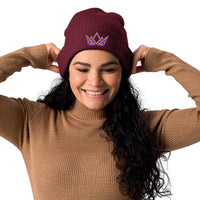 Woman wearing burgundy Royalty beanie – cuffed fit with purple and gold embroidered crown