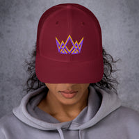 Woman wearing cranberry Christian trucker hat – bold stitched crown logo in purple and gold