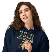 Zoomed-in view of female model wearing My Breath Bears His Name Hoodie in Navy, front glowing breath design