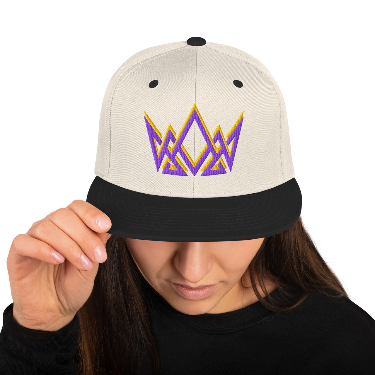 Woman wearing natural and black Christian snapback – purple and gold embroidered crown on flat bill cap