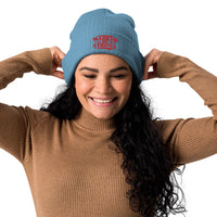 Woman wearing light blue Marked by Stripes beanie – red gospel embroidery on cuff