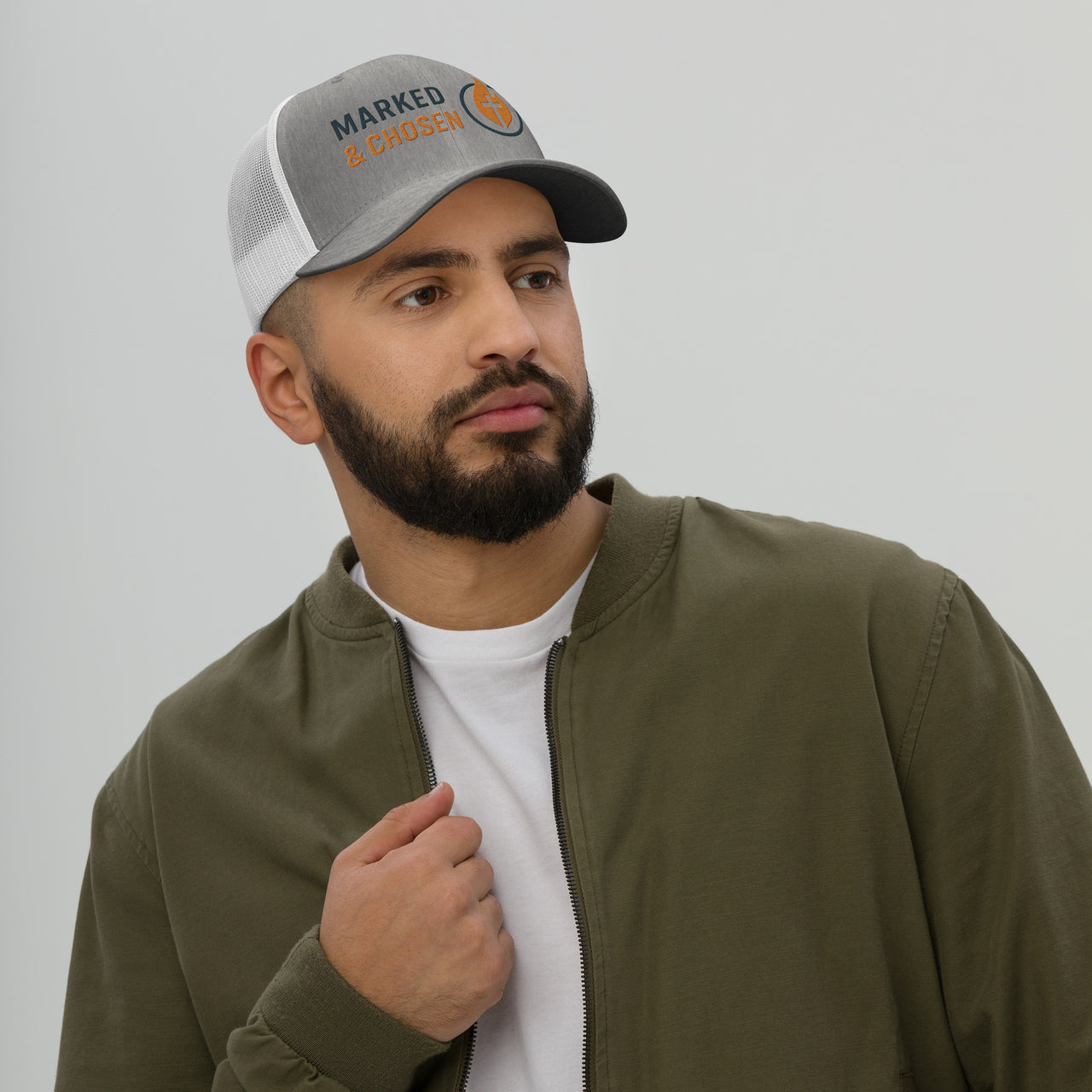 Male Model wearing Heather gray and white mesh cap featuring Marked & Chosen logo – faith-based snapback