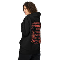 Woman wearing black Christian hoodie – red By His Stripes We Are Healed on the back