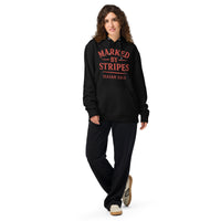 Woman wearing black Christian hoodie – red Marked by Stripes logo on chest