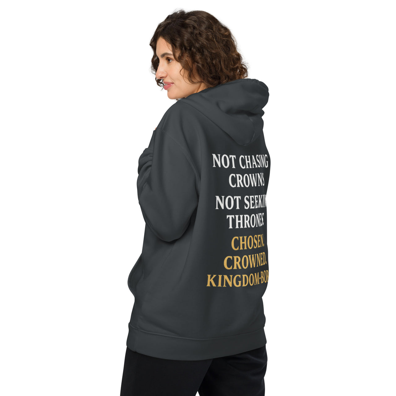 Female model in dark grey Christian hoodie – printed back features word stack: “Not Chasing Crowns. Not Seeking Thrones. Chosen. Crowned. Kingdom-Born.”