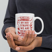 Model holding 11oz Christian mug – Isaiah 53:5 scripture facing front in bold red print