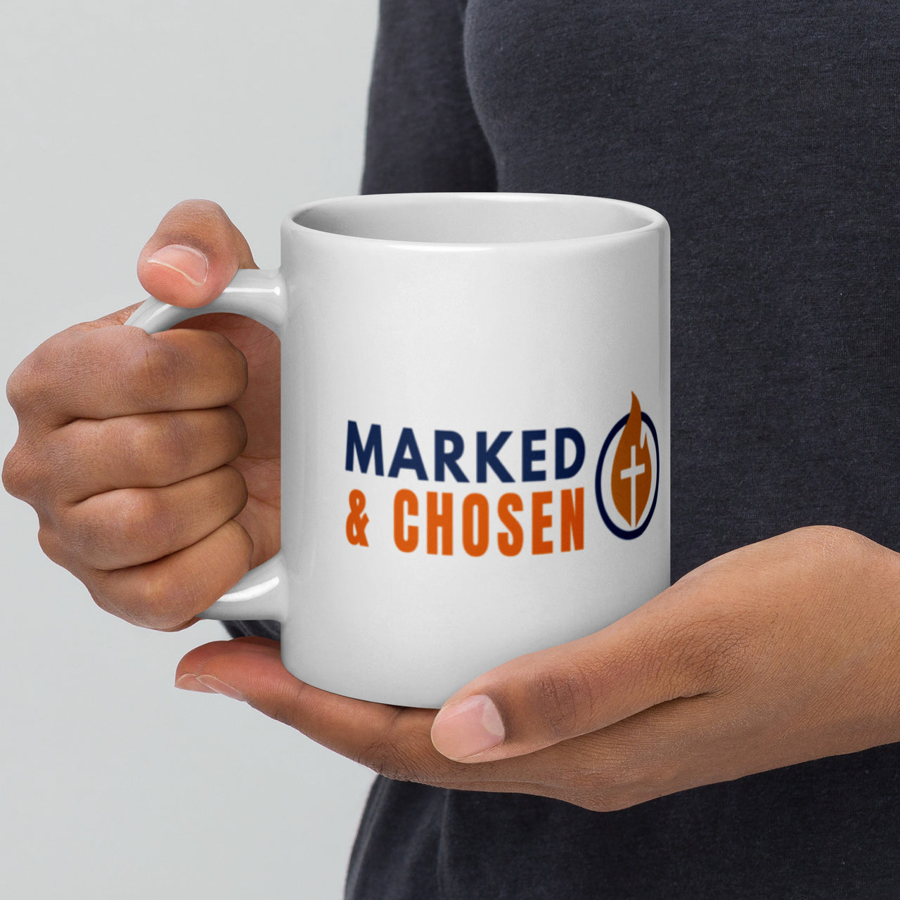 Model holding large 20oz white Christian mug – Marked & Chosen logo on display