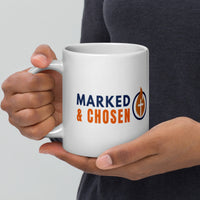 Model holding large 20oz white Christian mug – Marked & Chosen logo on display
